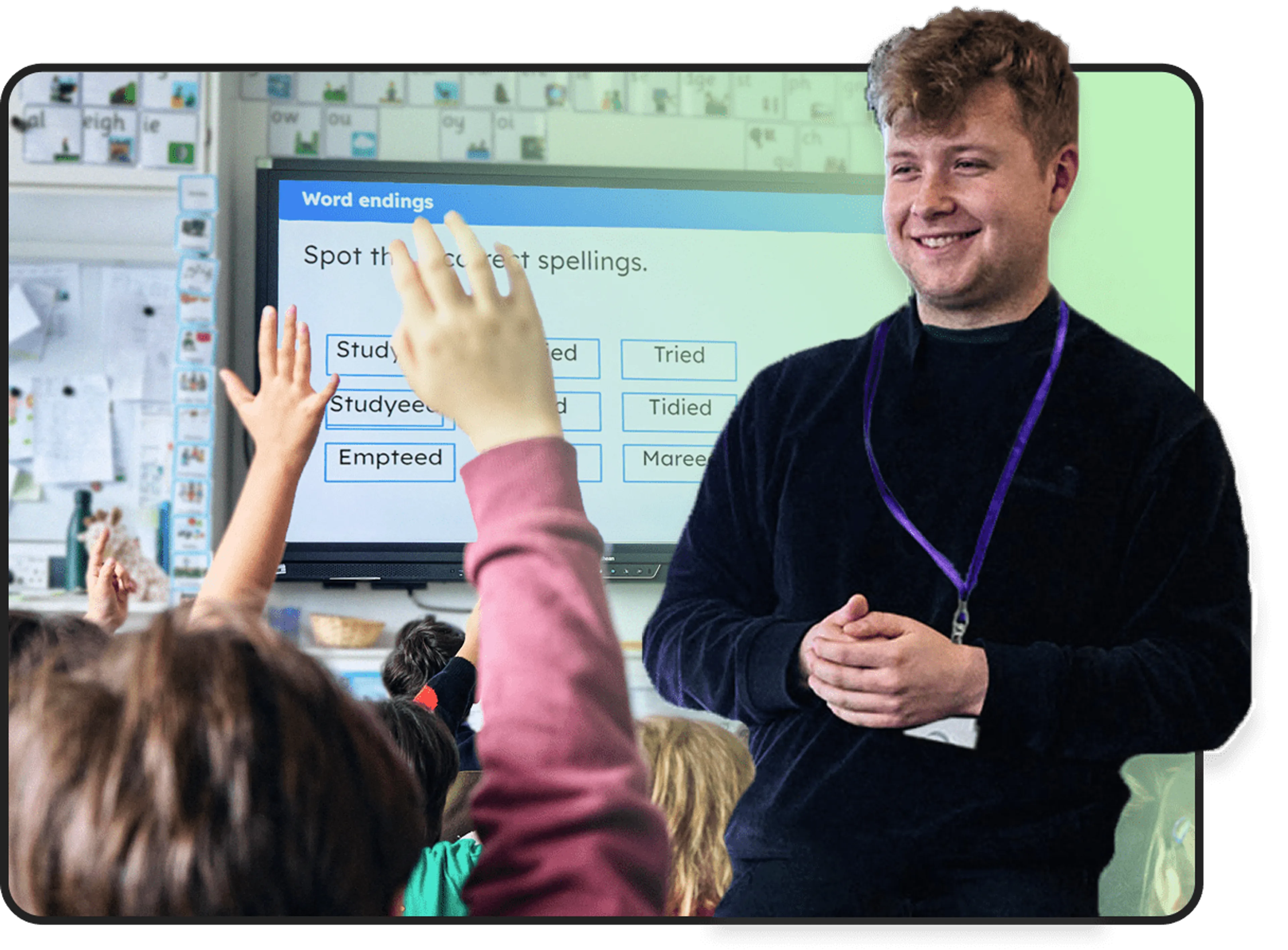 A teacher smiling in a classroom full of children raising their hands