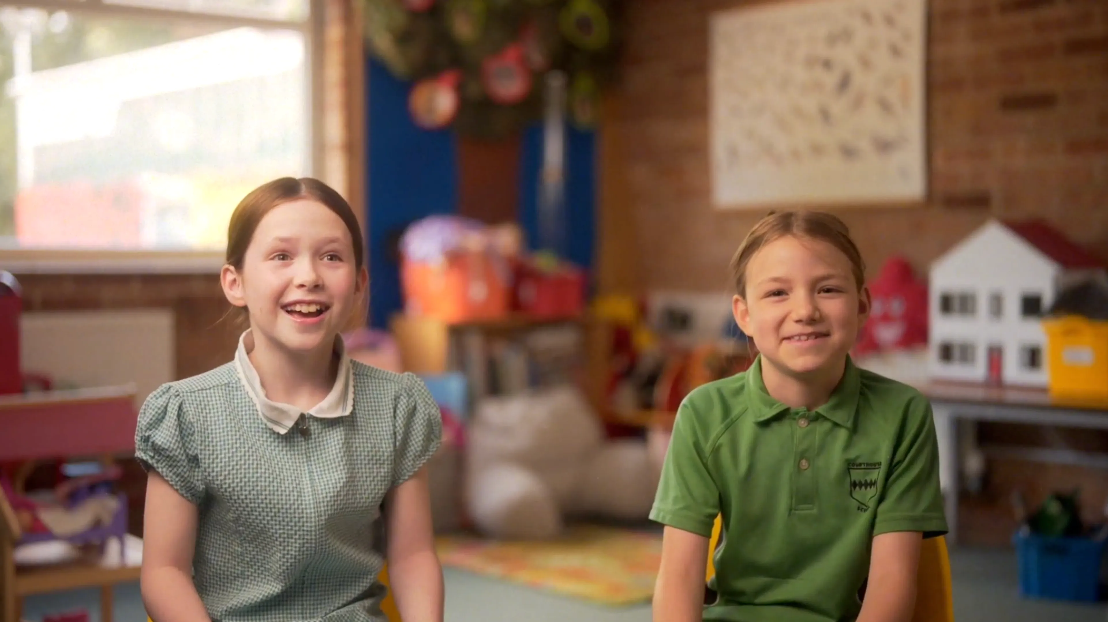 Two pupils laughing in a classroom 